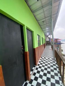 a building with a checkered floor and green at WD adventure Pangalengan in Palayangan +1 photo