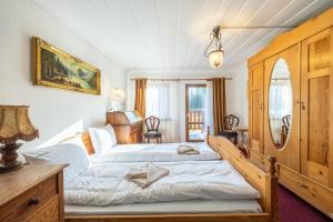 a large bedroom with two beds and a dresser at Dom Szklarski Kamień in Szklarska Poręba