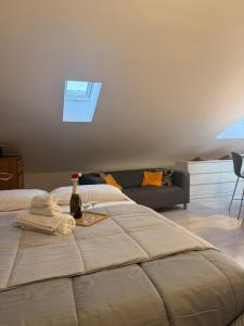 a bedroom with a bed with a bottle of wine on it at Avigliana Einaudi in Avigliana