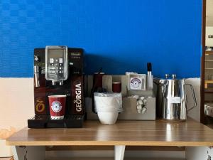 a table with a coffee machine and cups on it at lodge EDMONTON in Yuzawa +31 photos