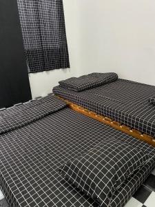 two beds sitting next to each other in a room at WD adventure Pangalengan in Palayangan