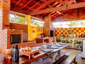 a large kitchen with a table with food on it at Sitio só Alegria com roupas de cama e banho in Guararema