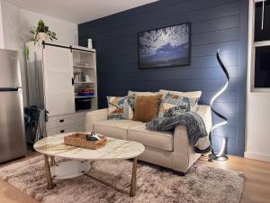 a living room with a couch and a table at Cuddle's Comfort & OCEAN in Daytona Beach