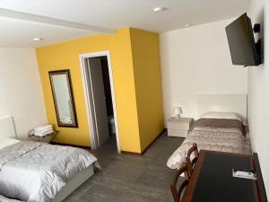 a hotel room with two beds and a television at Agriturismo il Casale in Ponte Galeria +159 photos