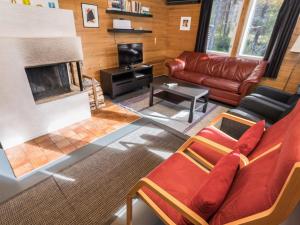 a living room with a couch and a fireplace at Holiday Home Rintelä 5a by Interhome in Ruka