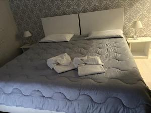 a bed with two towels and two pillows on it at Agriturismo il Casale in Ponte Galeria