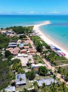 an aerial view of a beach with houses and the ocean at casa passos e reis in Corumbau