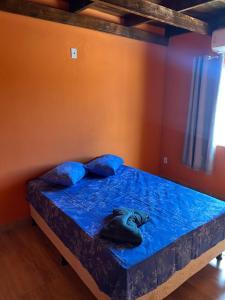 a bedroom with a bed with a fish head on it at casa passos e reis in Corumbau +6 photos