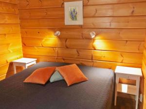 a bedroom with a bed with two pillows on it at Holiday Home Joutsen a by Interhome in Ruka +18 photos