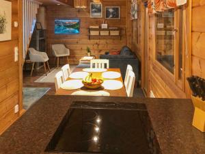 a kitchen and living room with a table in a cabin at Holiday Home Joutsen a by Interhome in Ruka