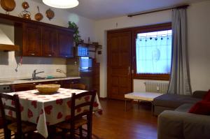 a kitchen and living room with a table with a table cloth at Casa Alpina Place in Isolaccia +9 photos