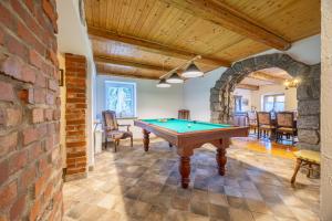 a pool table in a room with a brick wall at Dom Szklarski Kamień in Szklarska Poręba