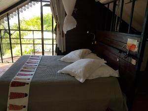 a bedroom with a bed with pillows on it at Villa THEOROM in Chambort