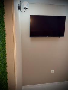 a flat screen tv hanging on a wall at Casa in centrul Chisinaului in Chişinău