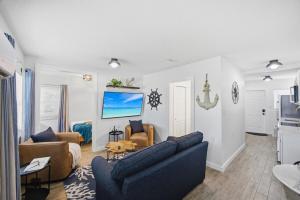 a living room with two couches and a table at 107 · Boat dock- BBQ Walk to Beach GREAT VIEWS in St. Pete Beach