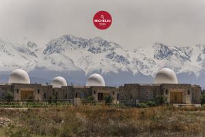 a building with snow covered mountains in the background at Chozos Resort in Agrelo +52 photos