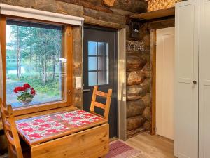 a room with a table and a window and a table and chair at Holiday Home Keloveska by Interhome in Ruka +12 photos