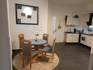 a kitchen and dining room with a table and chairs at Casa Mia in Goslar