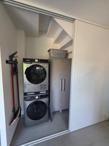 a washer and dryer in a small room at Tiboulen - Ste Luce sur Loire in Sainte-Luce-sur-Loire +10 photos