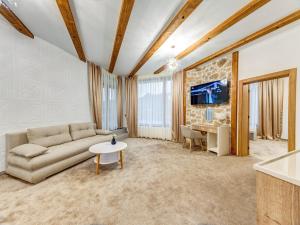 a living room with a couch and a table at Къща за гости "Mirror Lake" in Smolyan