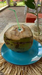 a banana sitting on a blue plate on a table at La Petite Maison in Antsiranana