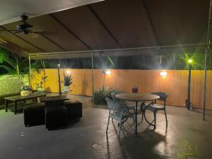 a patio with a table and chairs and a fence at Oceans Beach Resort 735 in Deerfield Beach