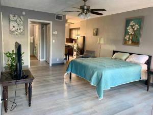a bedroom with a bed and a television in it at Oceans Beach Resort 735 in Deerfield Beach