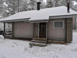 a small house with snow on top of it at Holiday Home Kitkaranta by Interhome in Kitka