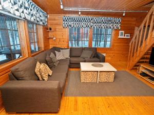 a living room with a couch and a table at Holiday Home Kitkaranta by Interhome in Kitka +26 photos