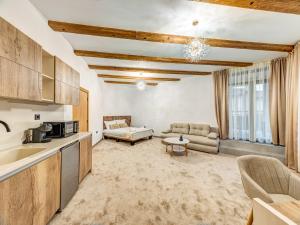a kitchen and living room with a couch and a table at Къща за гости "Mirror Lake" in Smolyan