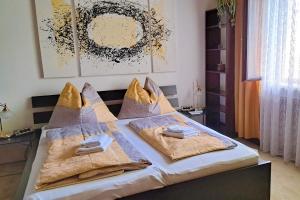 a bedroom with a bed with towels on it at Apartment Wurth in Groß-Siegharts