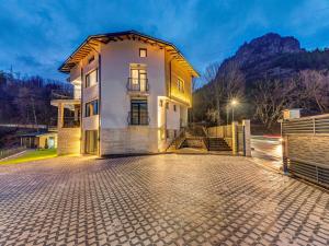 a house with a driveway in front of it at Къща за гости "Mirror Lake" in Smolyan