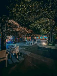 a group of tables and chairs under a tree at night at Happy Laugh Ella in Ella +27 photos