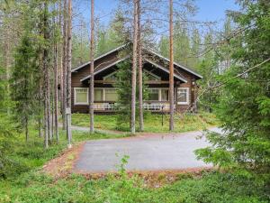 a log cabin in the woods with a driveway at Holiday Home Artturi by Interhome in Levi +14 photos