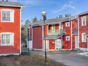a street light in front of a red building at Holiday Home Moitakuru a5 by Interhome in Saariselka