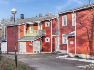 a red brick building with a balcony on it at Holiday Home Moitakuru a5 by Interhome in Saariselka