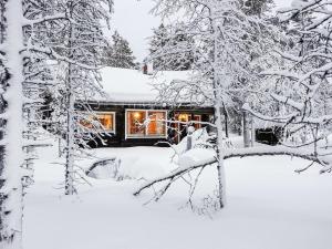 a cabin in the woods in the snow at Holiday Home Villemi by Interhome in Saariselka +18 photos