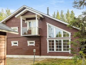 a house with red siding and white windows at Holiday Home Atrin suvanto a by Interhome in Levi