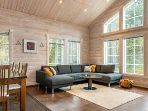 a living room with a couch and a table at Holiday Home Atrin suvanto a by Interhome in Levi