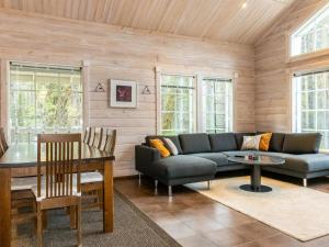 a living room with a couch and a table at Holiday Home Atrin suvanto a by Interhome in Levi +14 photos