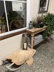 a table with a candle on it next to a window at Penzion WIESEN in Meziměstí