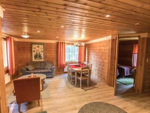 a living room with a couch and a table at Holiday Home Suvantovirta by Interhome in Kaukonen