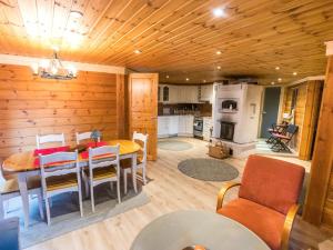 a kitchen and dining room with a table and chairs at Holiday Home Suvantovirta by Interhome in Kaukonen +12 photos