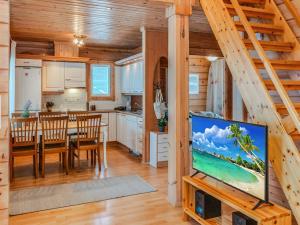 a kitchen and dining room with a flat screen tv at Holiday Home Ojala by Interhome in Virta