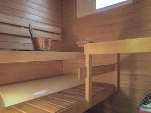 a wooden cabin with a shelf and a bucket in it at Holiday Home Moitakuru a14 by Interhome in Saariselka