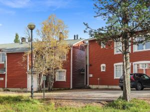 a red house with a car parked in front of it at Holiday Home Moitakuru a14 by Interhome in Saariselka