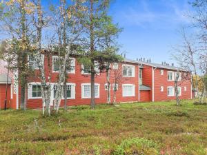 a large red building with trees in front of it at Holiday Home Moitakuru a14 by Interhome in Saariselka +8 photos