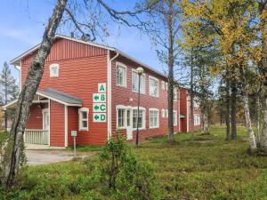a red building with a sign in front of it at Holiday Home Moitakuru a14 by Interhome in Saariselka