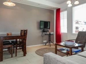 a living room with a table and a tv at Holiday Home Levi star 2- as- 409 by Interhome in Levi +14 photos