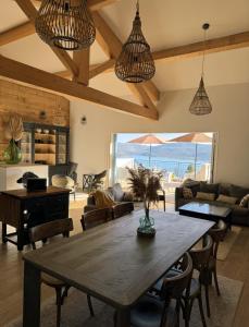 a living room with a wooden table and a dining room at Villa Fautea Verdon in Sainte-Croix-de-Verdon